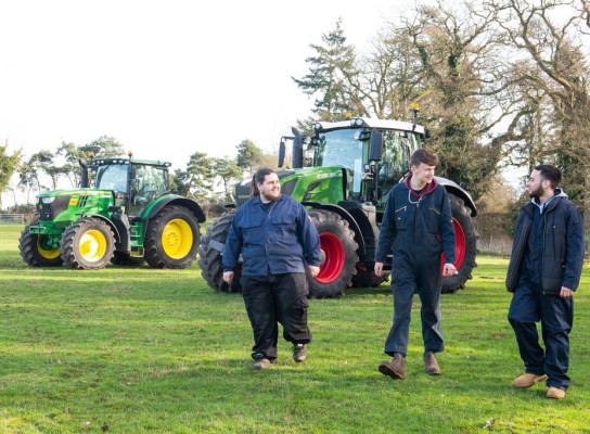 Agriculture students in field with tractors