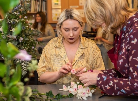 Student working in floristry cutting room