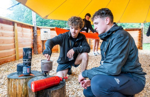 Two Outdoor Leadership students engaged in bushcraft activities