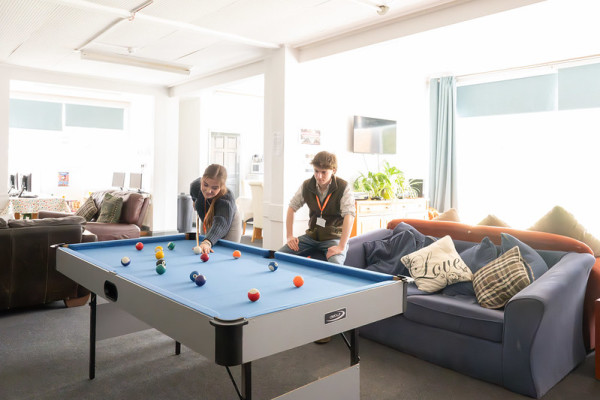 Students playing pool in the common roomin with our halls of residence.