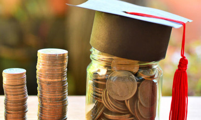 Columns of pennies with jar of pennies wearing graduation cap
